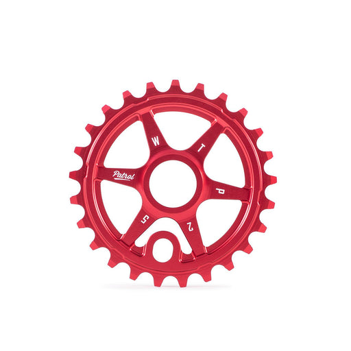 Red WETHEPEOPLE PATROL SPROCKET made from 6061-T6 alloy with CNC construction and offset teeth for BMX bikes.