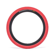 WETHEPEOPLE ACTIVATE TIRE with red sidewall, designed for durability and grip, featuring fast-rolling tread and cobweb technology.