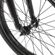 Close-up of the front wheel and fork of the Wethepeople Justice Bike featuring black spokes and hub guards.
