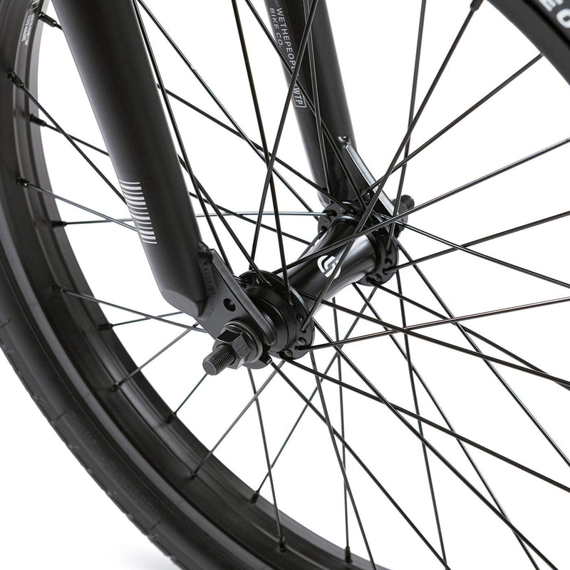 Close-up of the front wheel and fork of the Wethepeople Justice Bike featuring black spokes and hub guards.