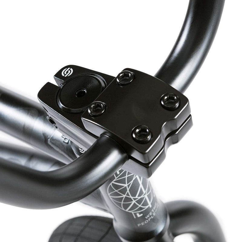 Close-up of black handlebar clamp and part of the frame of the Wethepeople Justice Bike with logo on the frame