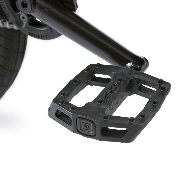 Close-up of black pedal on Wethepeople Justice Bike with sturdy plastic platform and grip pins