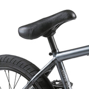 Close-up of the Wethepeople Justice Bike black padded seat, frame, and rear tire with Activate tire tread visible.