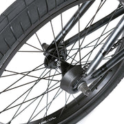 Close-up of Wethepeople Justice Bike rear wheel hub and spokes with black Activate tire and sturdy steel frame components