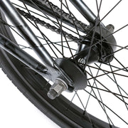Close-up of rear wheel hub and spokes on WETHEPEOPLE JUSTICE BIKE showing black hub, chain, and metal frame components