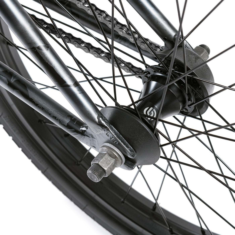 Close-up of rear wheel hub and spokes on WETHEPEOPLE JUSTICE BIKE showing black hub, chain, and metal frame components