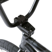 Close-up of black handlebars, stem, and front tire on the WETHEPEOPLE JUSTICE BIKE featuring a sturdy frame and urban BMX design
