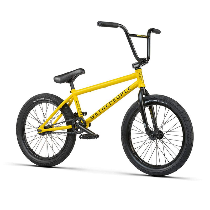 Yellow Wethepeople Justice BMX complete bike with black tires and handlebars, featuring Wethepeople branding on the frame.