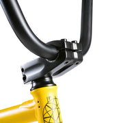 Close-up of Wethepeople Justice Bike yellow frame and black handlebars with sealed headset and stem details