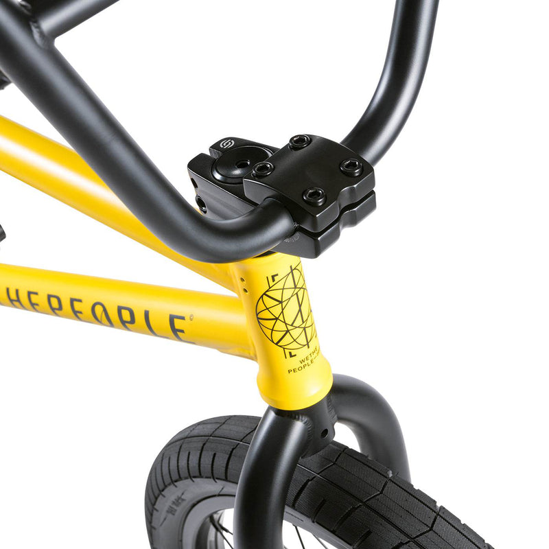 Close-up of the Wethepeople Justice Bike yellow frame and black handlebars with front tire visible