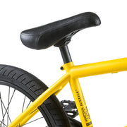 Close-up of black seat and rear wheel on yellow WETHEPEOPLE JUSTICE BIKE with activated tires and sturdy frame