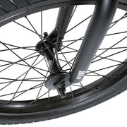 Close-up of the front wheel and fork of the WETHEPEOPLE JUSTICE BIKE showcasing the black rim, spokes, and hub with a 22mm offset fork design