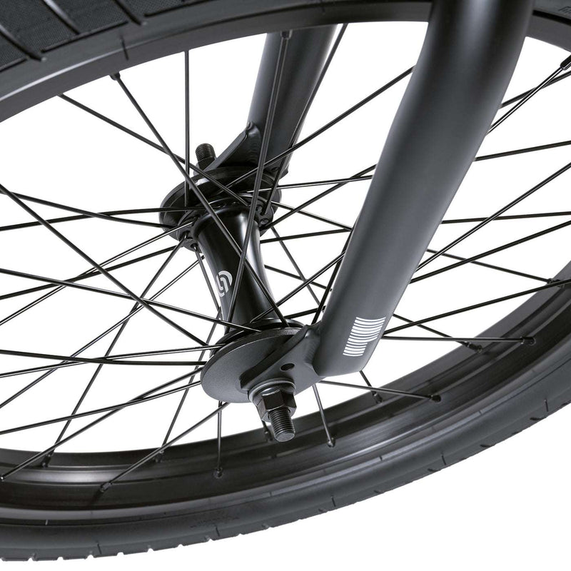 Close-up of the front wheel and fork of the WETHEPEOPLE JUSTICE BIKE showcasing the black rim, spokes, and hub with a 22mm offset fork design