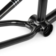 Close-up of black WETHEPEOPLE PATHFINDER BMX frame bottom bracket and chainstay section with smooth welds and glossy finish