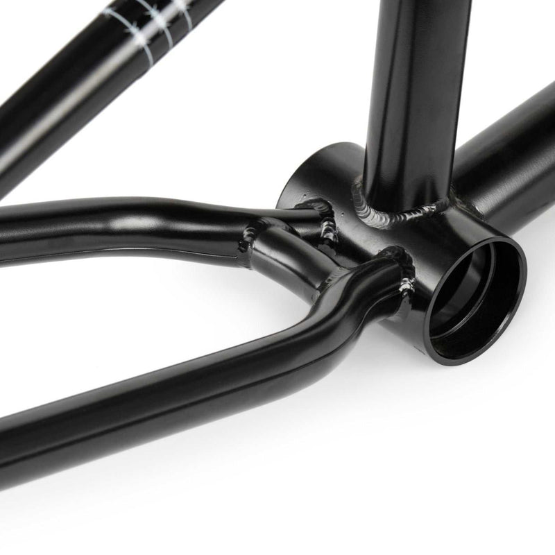 Close-up of black WETHEPEOPLE PATHFINDER BMX frame bottom bracket and chainstay section with smooth welds and glossy finish
