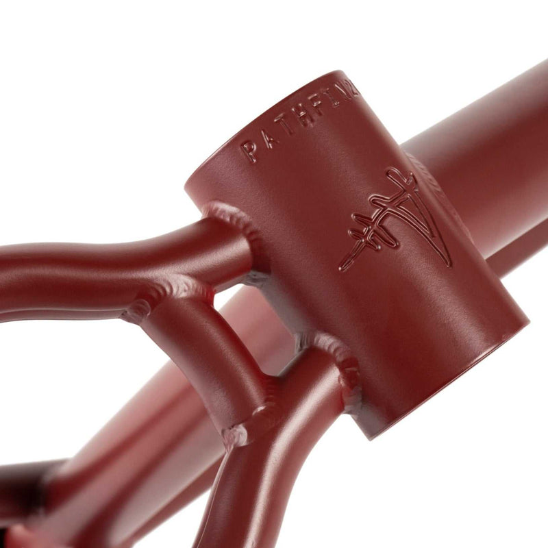 Close-up of burgundy WETHEPEOPLE PATHFINDER Frame head tube and welds with embossed logo and signature detailing