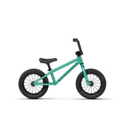WETHEPEOPLE PRIME 12" balance bike in teal with knurled footpegs and professional BMX design for young riders