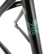 Close-up of the WETHEPEOPLE TRIGGER FRAME black BMX bike frame with turquoise logo and text on the tubing.