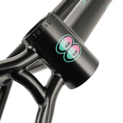 Close-up of WETHEPEOPLE TRIGGER FRAME BMX bike frame in black with turquoise and pink eye logo on the head tube