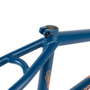 Close-up of blue WETHEPEOPLE TRIGGER FRAME BMX bike frame with durable butted Japanese 4130 crmo tubing and machined clamp collar