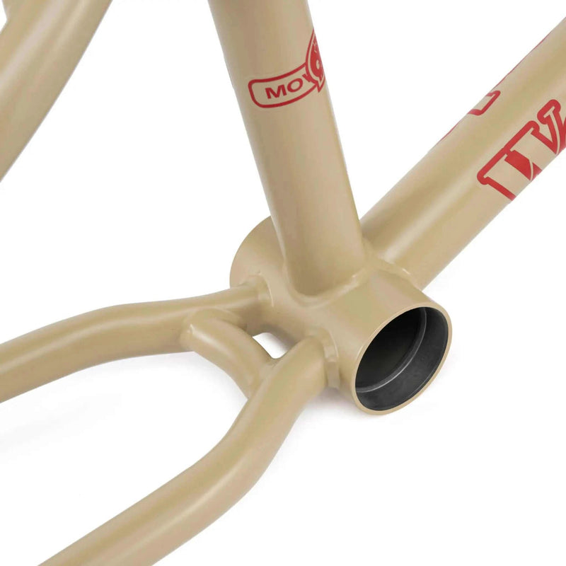 Close-up of the WETHEPEOPLE TRIGGER FRAME bottom bracket and chainstay junction in matte tan color.