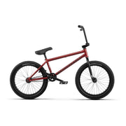 Red WETHEPEOPLE JUSTICE COMPLETE BIKE with black tires and seat, designed for BMX riding.