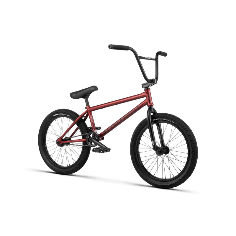 Wethepeople Justice Bike in red with black wheels and handlebars, complete BMX bike designed for urban riding.