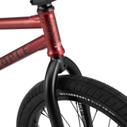 Close-up of the front section of the WETHEPEOPLE JUSTICE BIKE showing the red frame, black 22mm offset fork, and Activate tire.