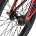 Close-up of rear wheel hub and black hub guard on red Wethepeople Justice bike frame with black tire and spokes