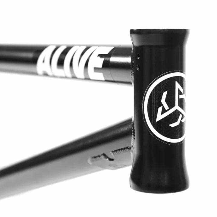Close-up of black ALIVE INDUSTRY F.T.W. BMX bike frame with white logo and 4130 CrMo tubing.
