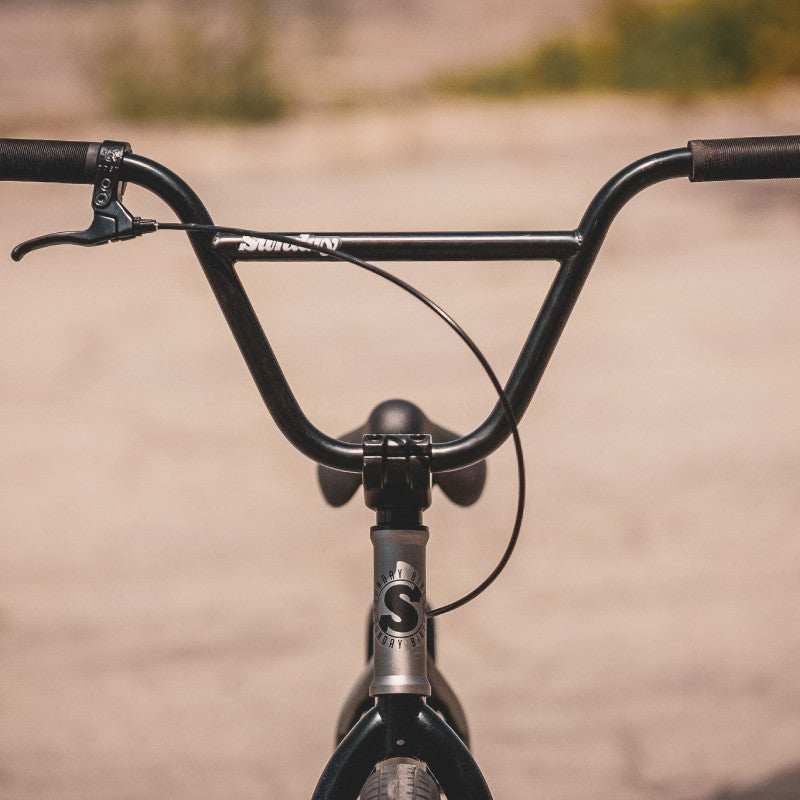 Close-up of Sunday Scout 20" BMX bike handlebars and front brake lever in matte black finish.