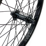 Close-up of a black CULT FREECOASTER hub driver on a bicycle wheel with spokes and rim branding visible
