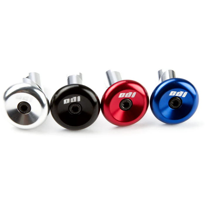 Set of ODI aluminum end plugs in silver, black, red, and blue anodized finishes for bike handlebar protection and customization.