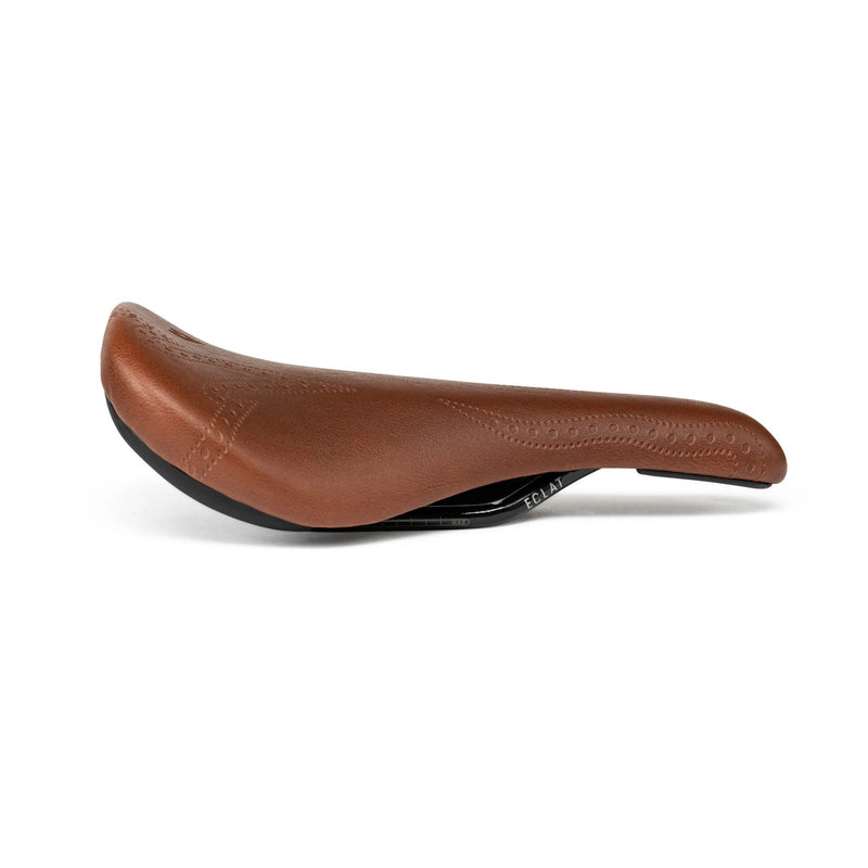 ÉCLAT EXILE X TYSON Railed Seat in brown faux-leather, contoured for comfort.
