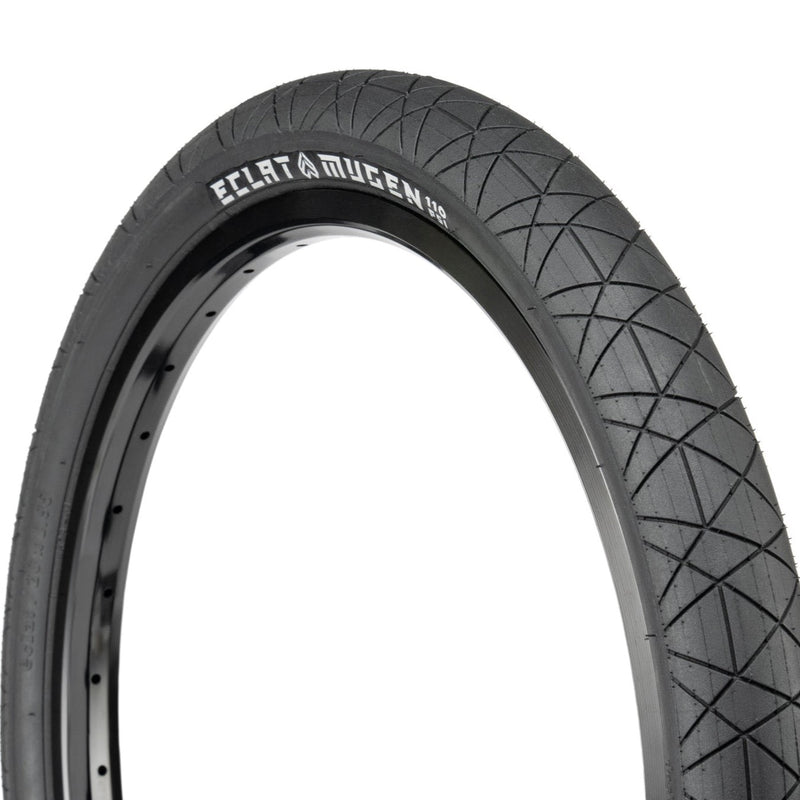 Éclat Mugen Tire for flatland BMX, black, ultra-round profile with micro-textured surface.