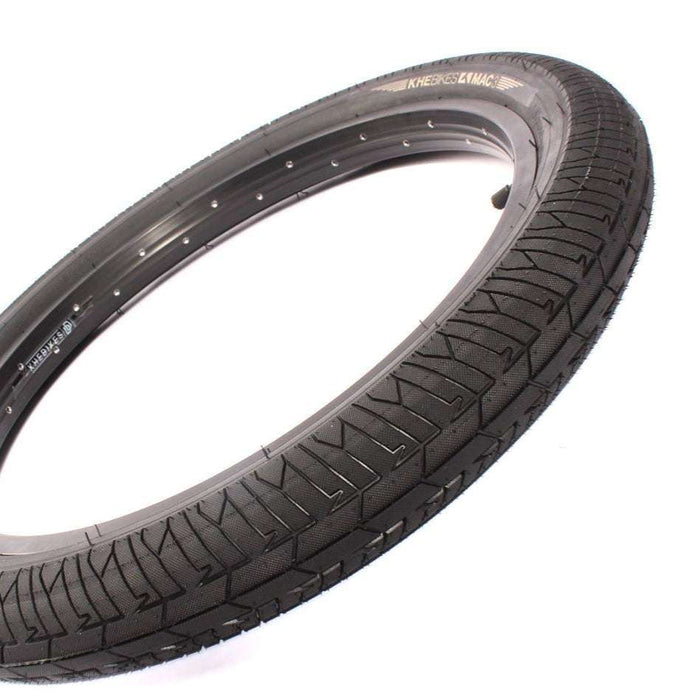 Black bicycle tire with tread pattern on a white background