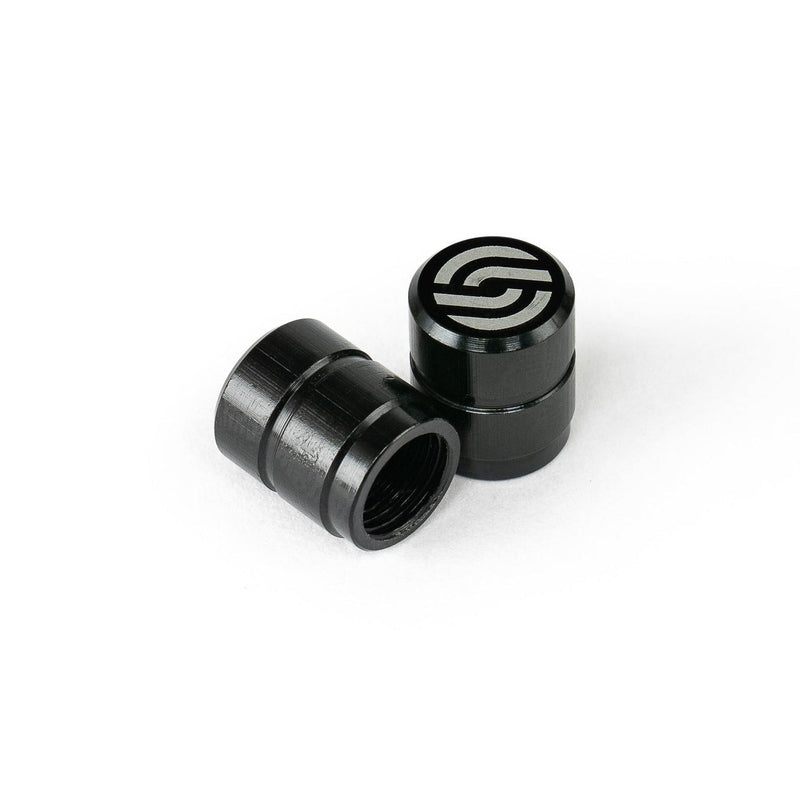 Black SALT CNC valve caps made from 6061-T6 alloy with laser logo, pair shown