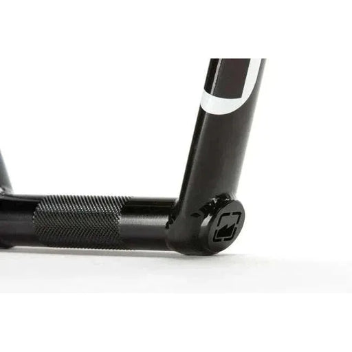 Close-up of black MERRITT SLAUGHTER 4PC BARS chromoly bike handlebars with reinforced welds and textured grip area