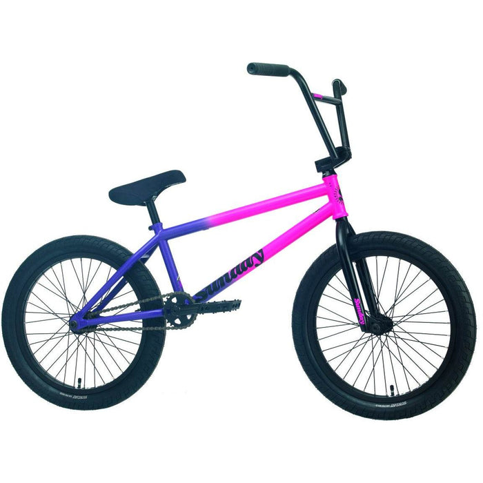 Sunday Street Sweeper BMX bike in matte hot pink to matte grape fade with black handlebars and tires designed for street riding.