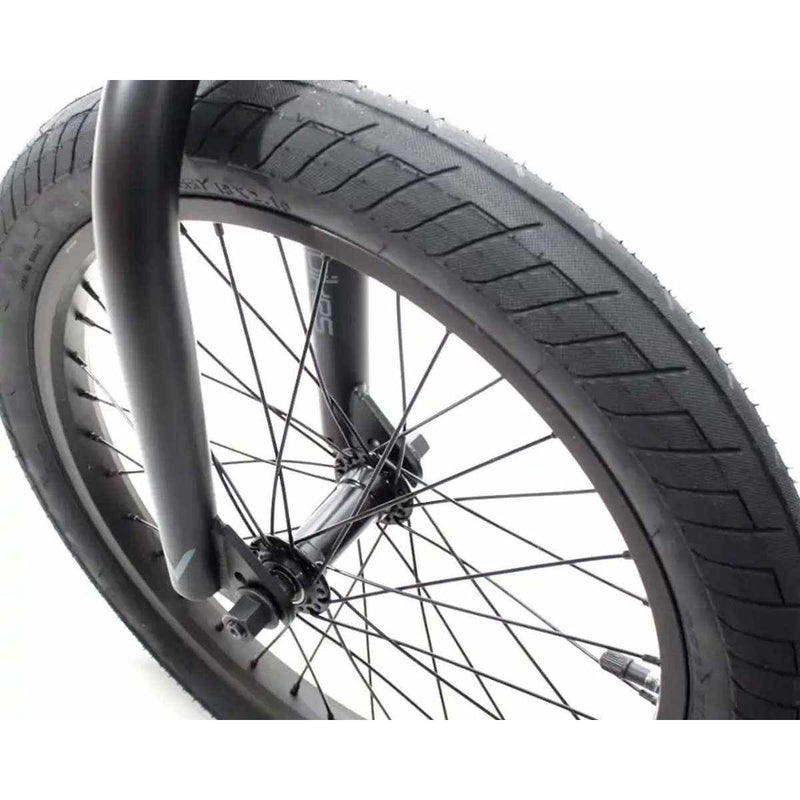 Close-up of front 18-inch wheel and tire on Verde Cadet 18 BMX bike with black spokes and fork