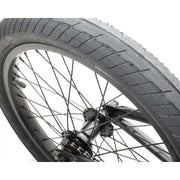Close-up of the front wheel of the Verde Cadet 18 BMX bike with 18-inch black tire and black spokes