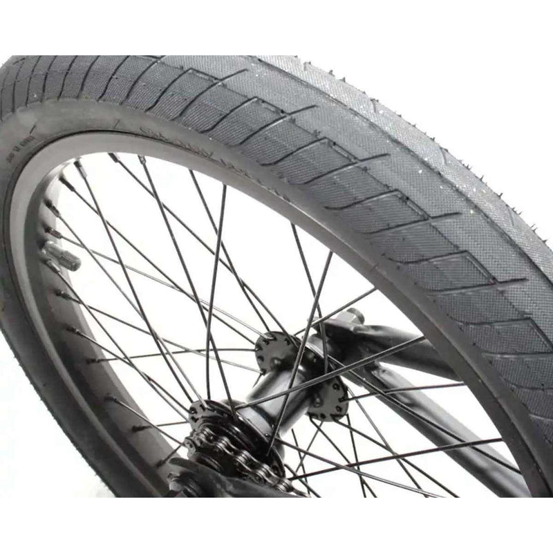 Close-up of the front wheel of the Verde Cadet 18 BMX bike with 18-inch black tire and black spokes