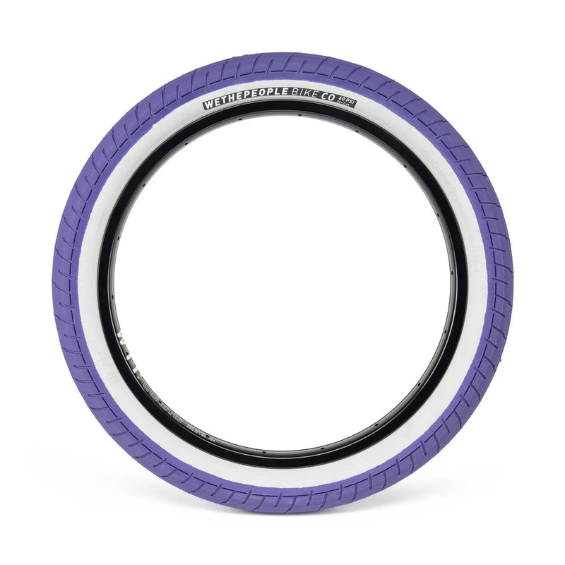 WETHEPEOPLE ACTIVATE TIRE with purple tread and white sidewall, designed for durability and grip.