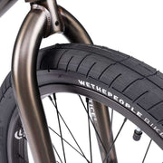 Close-up of Wethepeople Justice Bike front tire and fork showing black Activate tire and 22mm offset Saltplus Justice fork