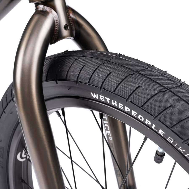 Close-up of Wethepeople Justice Bike front tire and fork showing black Activate tire and 22mm offset Saltplus Justice fork