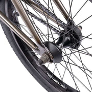 Close-up of the rear wheel and hub of the WETHEPEOPLE JUSTICE BIKE showing the chain, spokes, and part of the frame in metallic color.