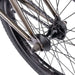 Close-up of the rear wheel and hub of the WETHEPEOPLE JUSTICE BIKE showing the chain, spokes, and part of the frame in metallic color.
