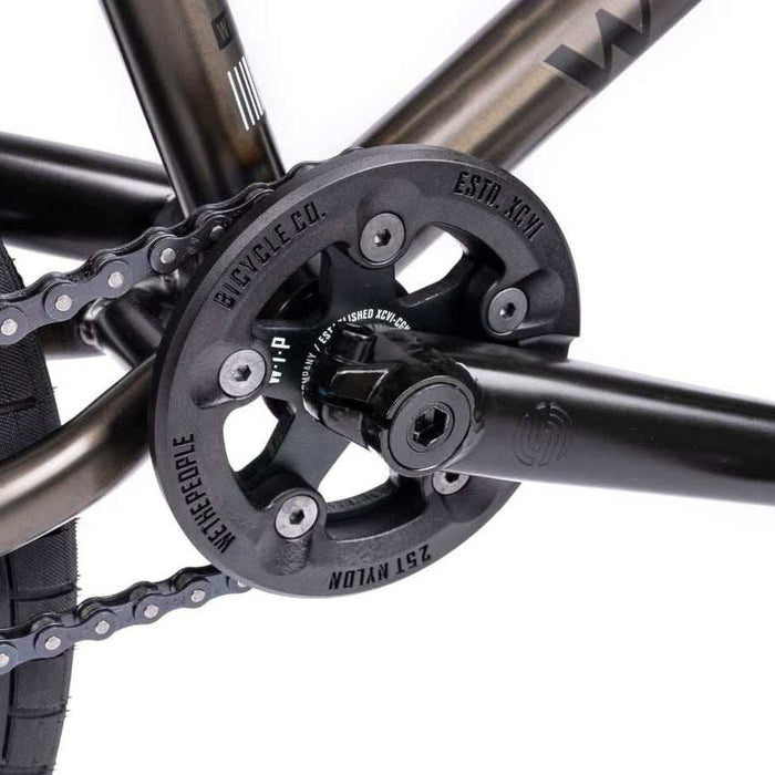Close-up of the Wethepeople Justice bike crankset with Paragon plastic guard and chain in black finish