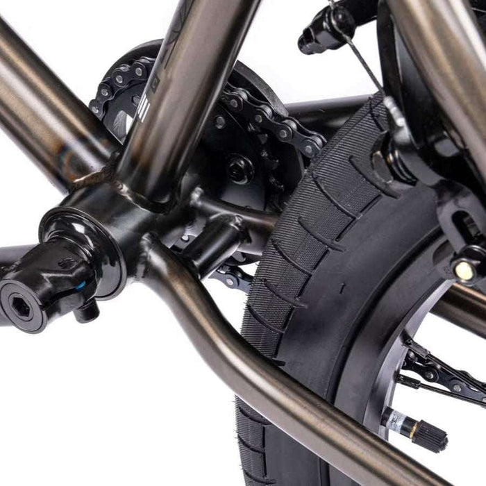 Close-up of the Wethepeople Justice Bike frame and rear wheel with chain and tire details