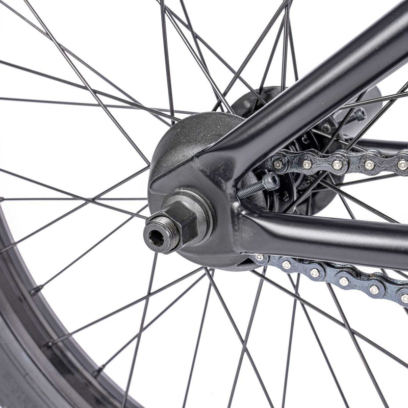 Rear wheel and chain of WETHEPEOPLE TRUST CS Complete Bike, featuring a durable design and high-performance components.